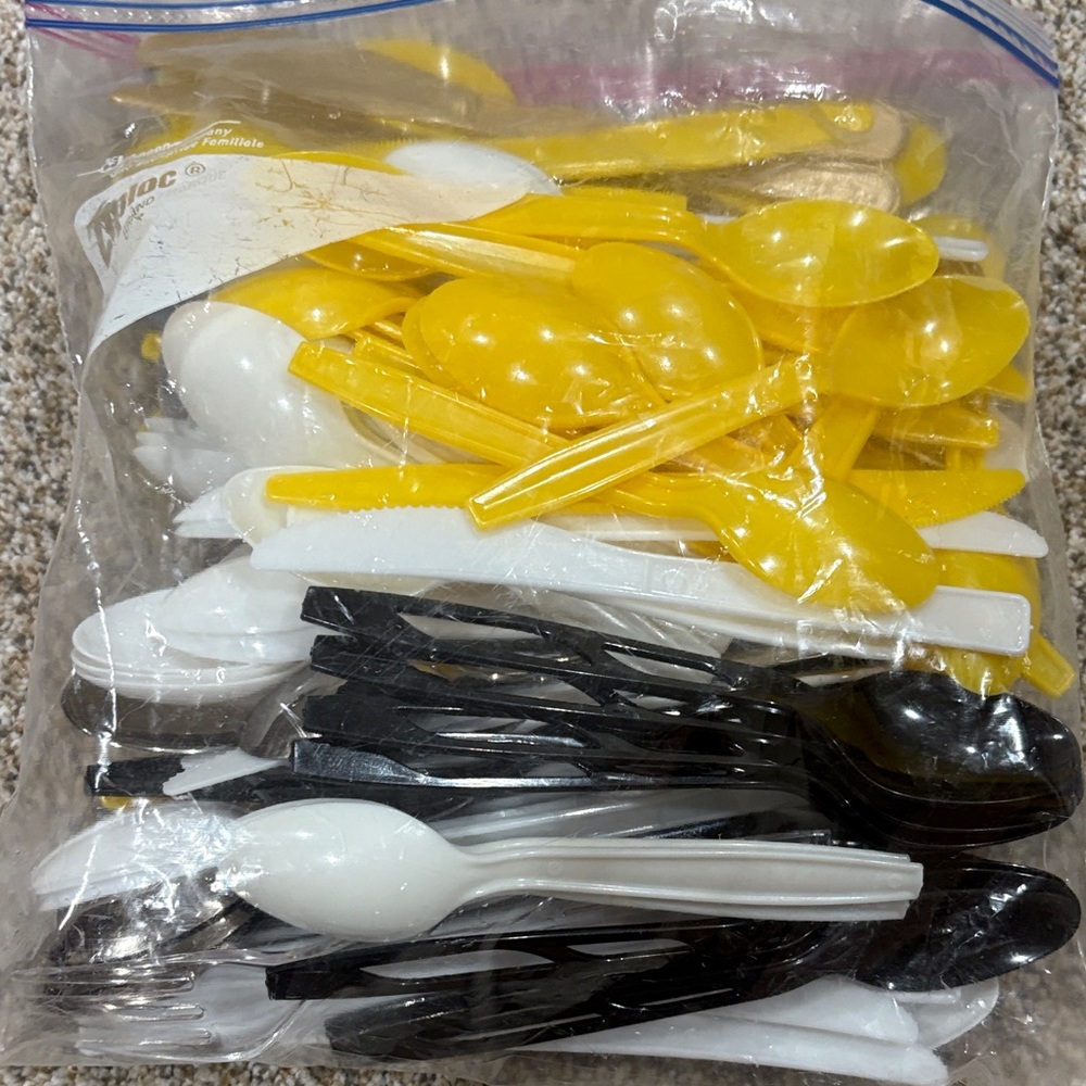 Yellow, White, and Black Plastic Cutlery Spoons and Knives